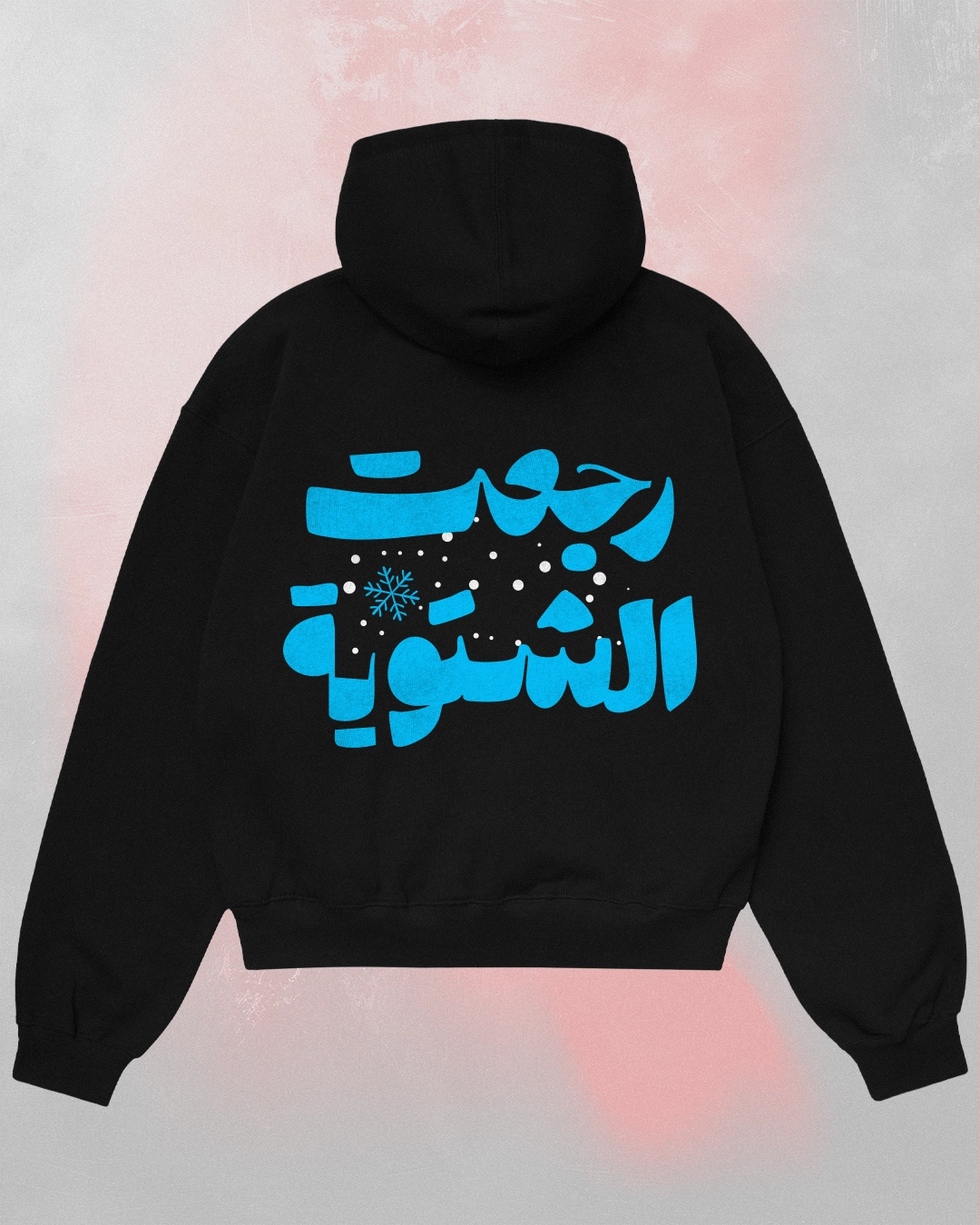 Oversized black hoodie seen from the back featuring "رجعت الشتوية" (Winter is Back Arabic Hoodie) in bright blue Arabic calligraphy.