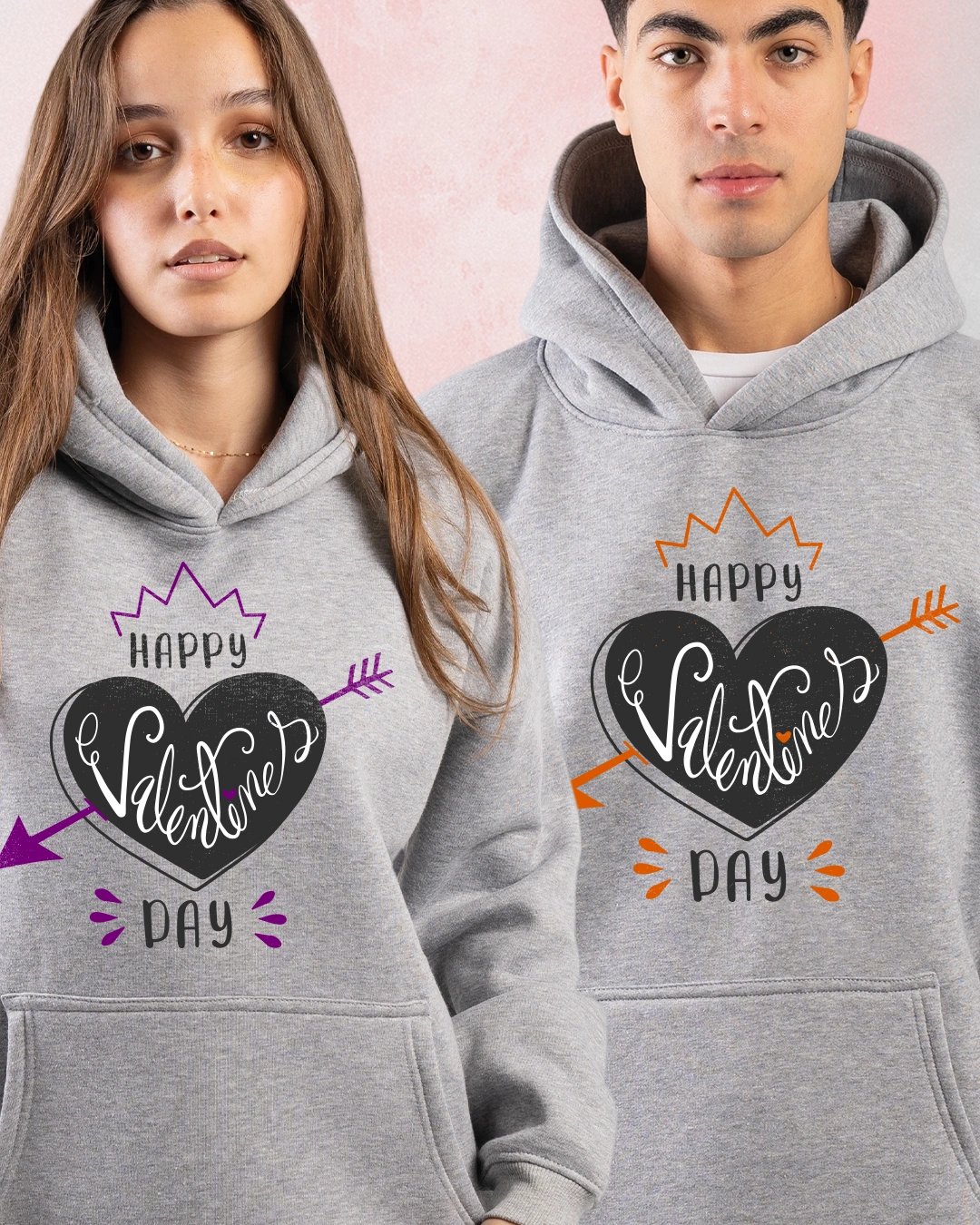 Valentine Couple Hoodie wearing matching grey hoodies with heart graphic and Happy Valentine Day text.